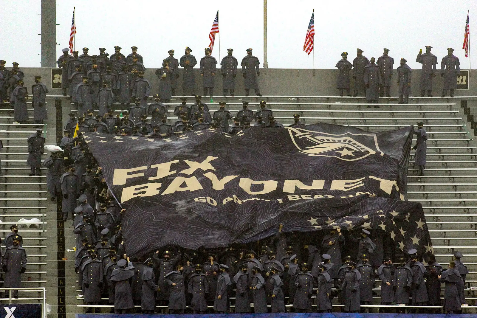 Army cadets in the stands holding a large banner at the 2020 Army-Navy Game
