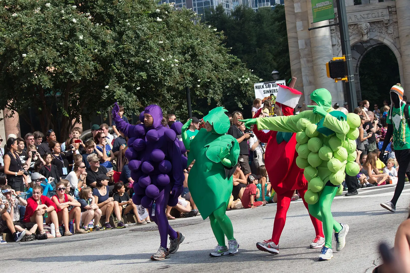 Costumed marchers walk down an Atlanta street in front of spectators at the 2013 Dragon Con parade