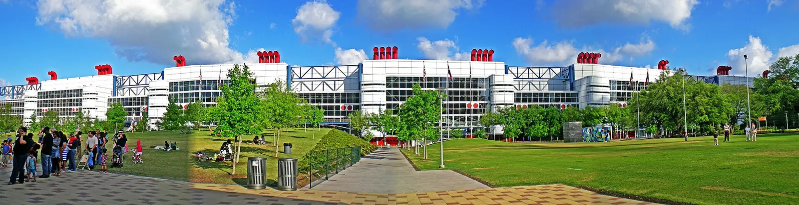 The white and steel facade of the George R. Brown Convention Center in Houston under a blue sky
