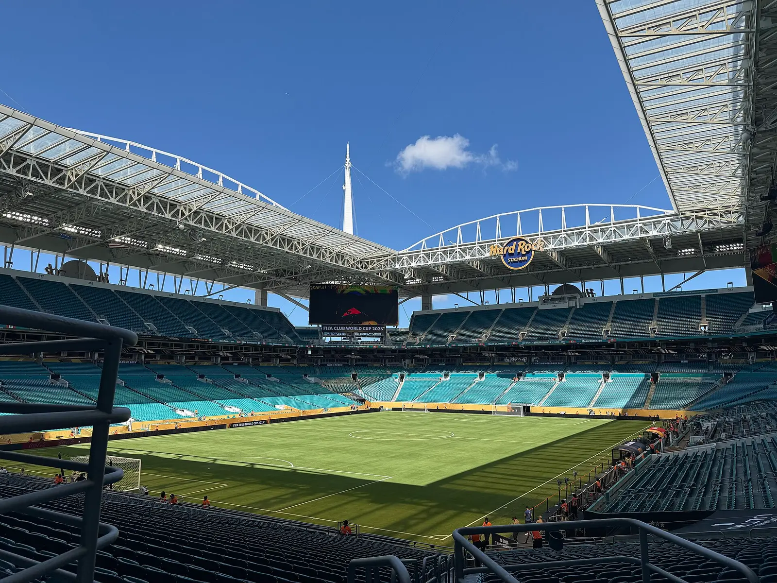 Interior of Hard Rock Stadium in Miami Gardens with turquoise seating and the open roof canopy