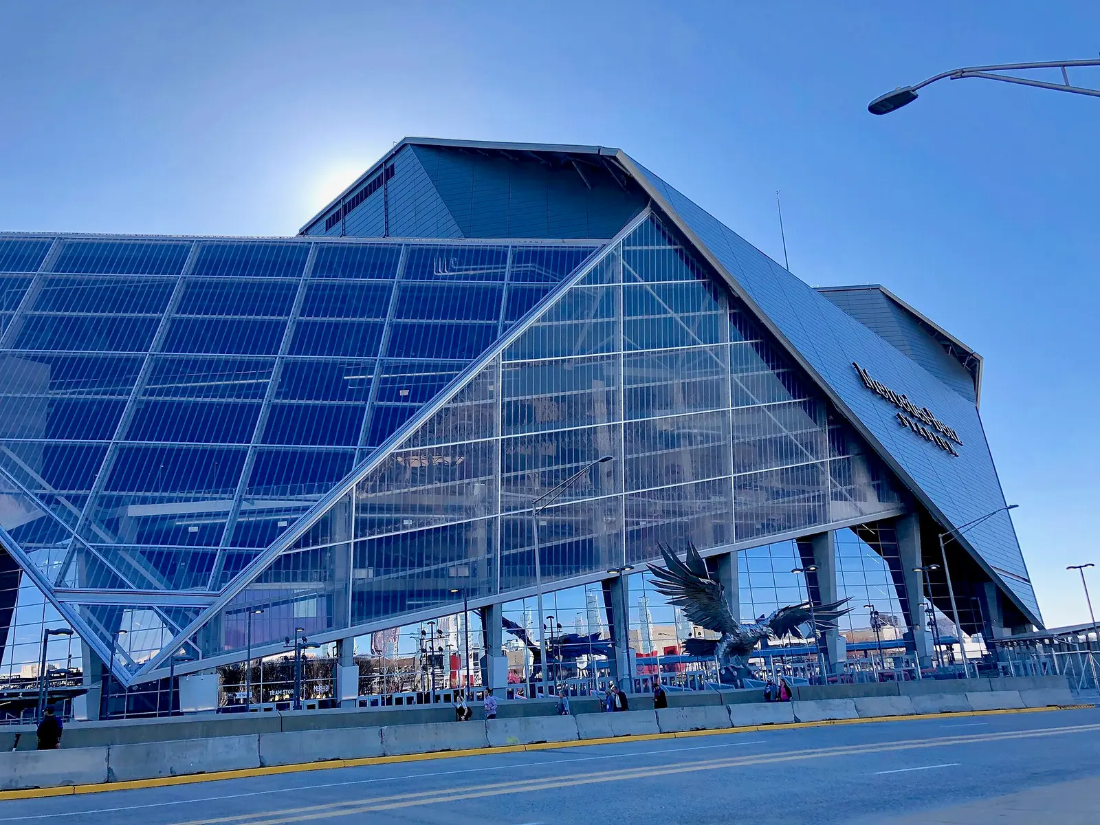 The glass-walled facade of Mercedes-Benz Stadium in Atlanta
