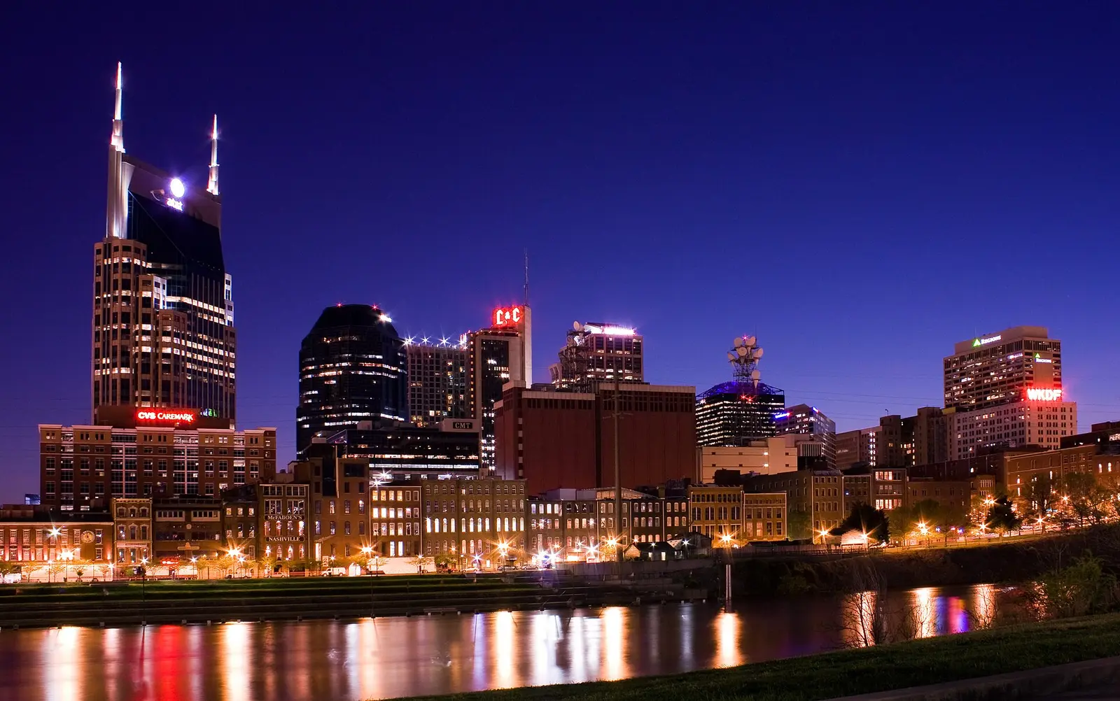 Downtown Nashville skyline with the AT&T Building lit at dusk across the Cumberland River