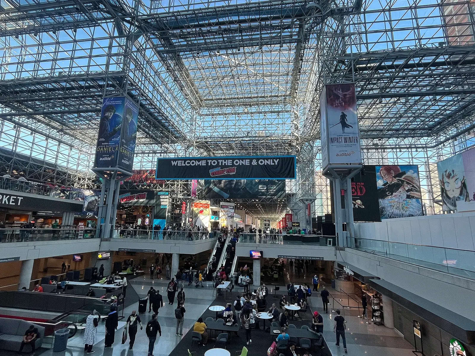 Crowds inside the glass atrium of the Javits Center during New York Comic Con 2022