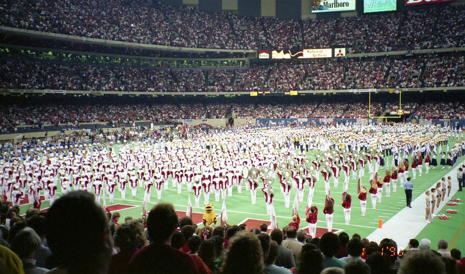 A marching band fills the turf of the Superdome before a Sugar Bowl in 1990